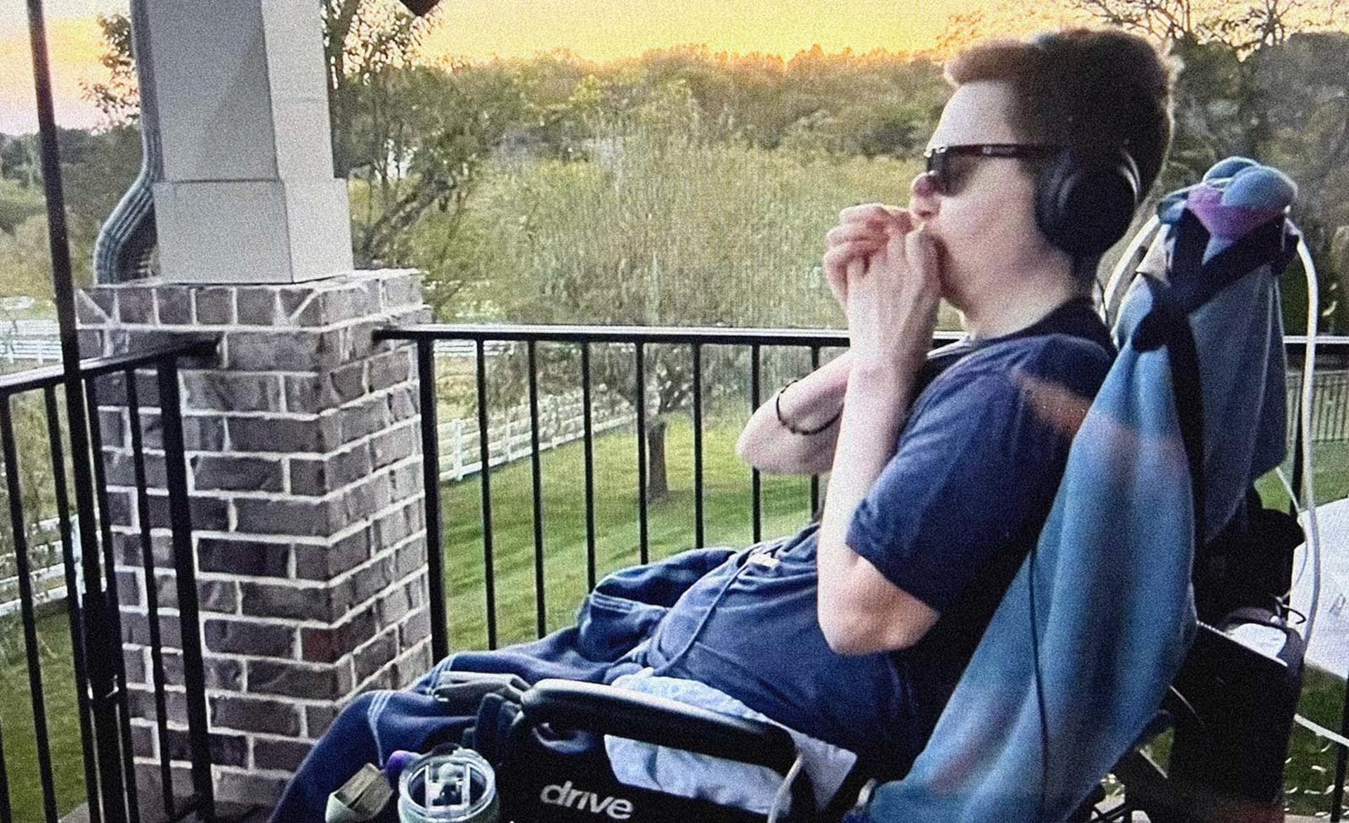Mac playing the harmonica.
